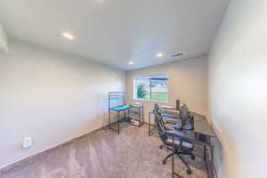 Carpeted bedroom with a textured ceiling and recessed lighting