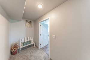 Corridor featuring carpet flooring and a textured ceiling
