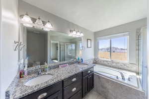 Bathroom with a garden tub, a shower stall, and light tile patterned floors