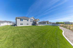 Back of house featuring landscaped yard
