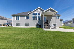 Rear view of property featuring patio area and  landscaped yard