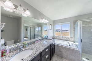 Bathroom with a bath, a stall shower, and light tile patterned flooring