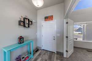 Entryway featuring baseboards and wood finished floors