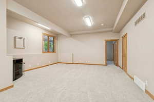 Below grade area with baseboards and light carpet