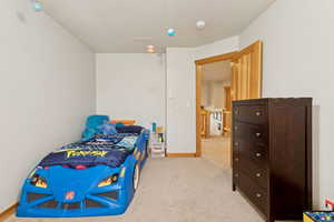 Bedroom featuring light carpet and baseboards