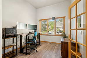 Office area with light wood-type flooring and baseboards