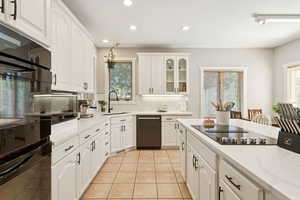 Kitchen featuring black appliances, recessed lighting, glass insert cabinets, white cabinetry, and decorative backsplash
