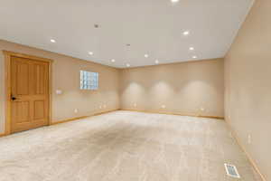 Spare room with recessed lighting and light colored carpet