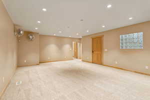 Empty room with recessed lighting and light colored carpet