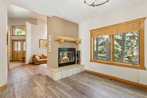 Living room featuring hardwood / wood-style flooring and a tile fireplace