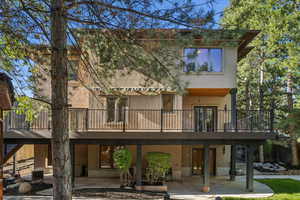 Rear view of property featuring stucco siding and a patio area