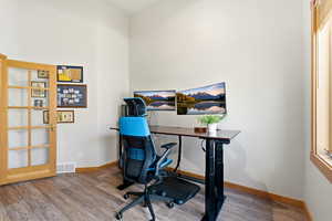 Office area featuring light wood-style floors and baseboards