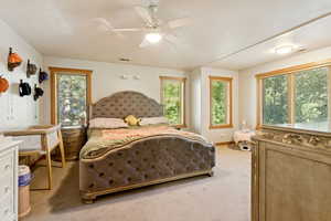 Bedroom with light colored carpet and ceiling fan