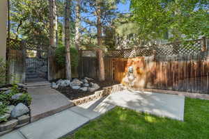 Fenced backyard with a patio area and a gate