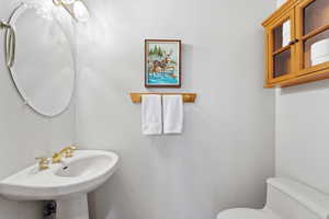 Half bathroom with toilet and a sink