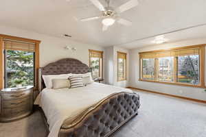 Bedroom featuring light colored carpet and a ceiling fan