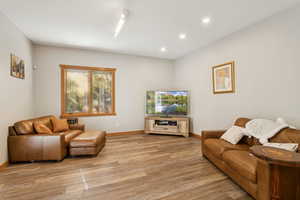 Living room with recessed lighting and light wood-style floors
