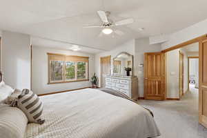 Bedroom featuring light colored carpet, a ceiling fan, and lofted ceiling
