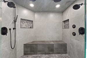 Full bathroom featuring tiled shower and recessed lighting
