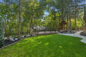 View of yard featuring a wooden deck and a gazebo
