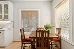 Dining room with light tile patterned floors and baseboards