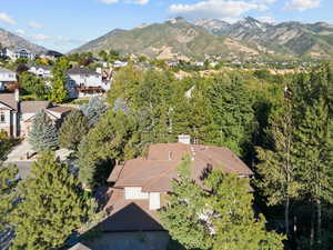 Aerial view of property and surrounding area with a mountainous background