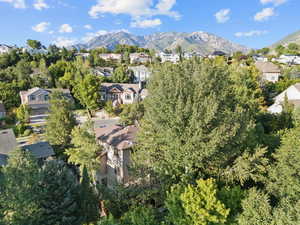 Aerial view of property's location featuring nearby suburban area and a mountainous background