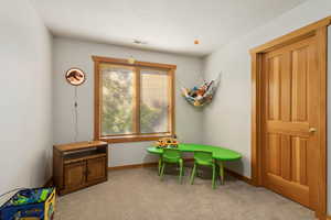 Playroom with light colored carpet and baseboards