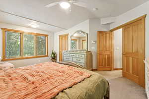 Bedroom featuring light carpet and a ceiling fan