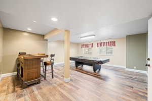Playroom with light wood-style flooring, billiards table, and recessed lighting
