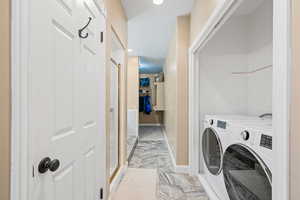 Laundry area with recessed lighting and independent washer and dryer