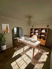 Office space featuring ornamental molding, arched walkways, and a chandelier