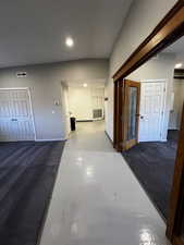Hallway featuring concrete flooring and recessed lighting