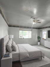 Bedroom featuring vaulted ceiling and a ceiling fan