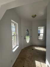 Foyer entrance with baseboards and tile patterned flooring