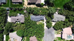 Aerial view of property and surrounding area featuring nearby suburban area