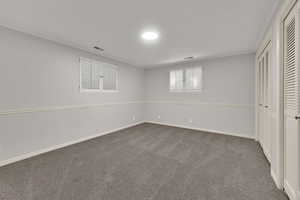 Unfurnished bedroom featuring carpet flooring and two closets