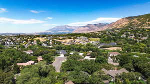 Aerial overview of property's location with nearby suburban area and mountains