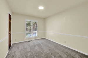 Carpeted empty room with baseboards