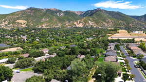 Aerial view of property's location featuring nearby suburban area and a mountainous background