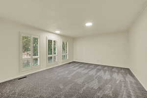 Empty room with crown molding, carpet flooring, and recessed lighting