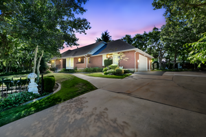 Single story home featuring brick siding, concrete driveway, a yard, and an attached garage