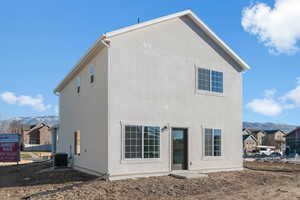 Rear view of house featuring a mountain view and stucco siding