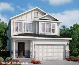 View of front of house with driveway, board and batten siding, an attached garage, a porch, and stone siding