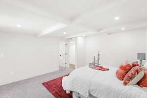 Bedroom with recessed lighting, beam ceiling, and light carpet