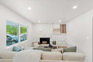Living room featuring a fireplace, wood finished floors, and recessed lighting