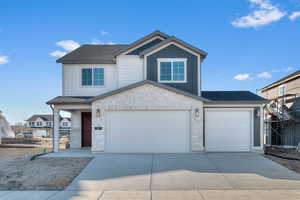 Craftsman inspired home with stone siding, a shingled roof, driveway, board and batten siding, and a garage