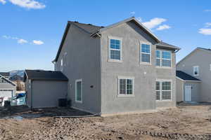Rear view of property featuring stucco siding