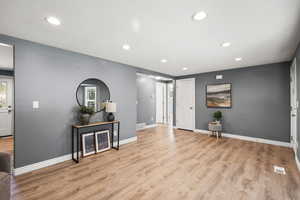 Foyer featuring light wood-style flooring and recessed lighting
