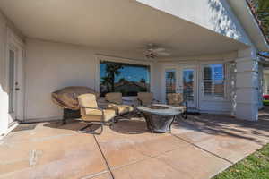 View of patio / terrace with a fire pit and a ceiling fan